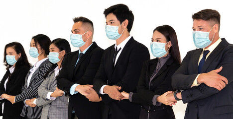 Confident business people with face mask protect from Coronavirus or COVID-19. Concept of help, support and collaboration together to overcome epidemic of Coronavirus or COVID-19 to reopen business.