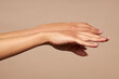 © Антон Пухов - Health and beauty. Female hands on a beige background without a cassette.