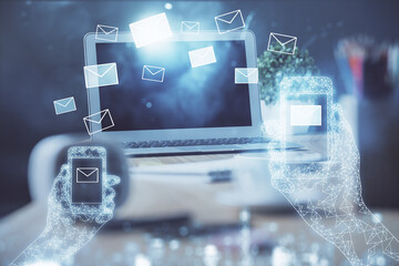 Desktop computer background in office and flying envelops hologram drawing. Multi exposure. Electronic mail concept.