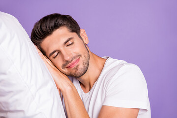 Close-up portrait of his he nice attractive sleepy brown-haired guy holding head on pillow drowsing fatigue bedtime isolated on bright vivid shine vibrant lilac violet purple color background