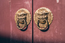 Golden Dragon Shape Doorknob On A Chinese Red Wooden Door.