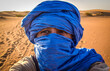 A tuareg takes a selfie in the desert
