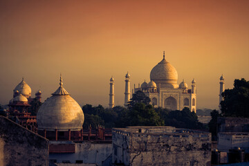 the magnificent taj mahal in india shows its full splendor at a glorious sunrise.