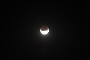 Wall Mural - lunar moon half eclipse on black night sky background