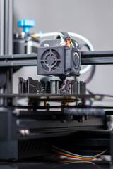 3D plastic printer during work in a factory three dimensional printing. Close-up detail.