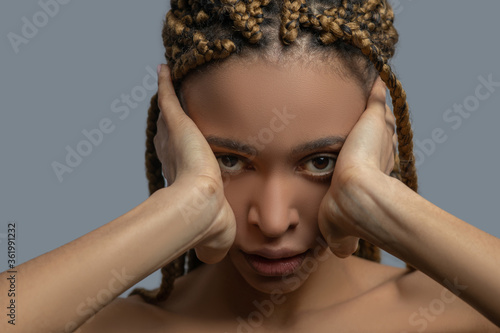 Cuadros en Lienzo Frustrated young African American woman covering her ears with hands