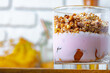 Berry youghurt with granola and fruits in a glass