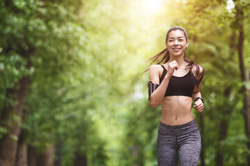 Healthy Lifestyle. Sporty Asian Girl In Jogging In City Park