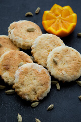 homemade cookies with cardamom and orange on a black background