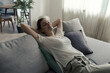 © stokkete - Happy woman lying on the sofa at home and relaxing