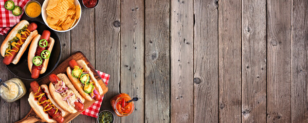 Wall Mural - BBQ hot dog corner border. Top view table scene with a dark wood banner background. Copy space.