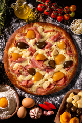 Wall Mural - Sweet pizza with peaches, fig and pineapple on black concrete background. Top view, close up. Traditional Brazilian Pizza