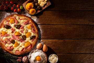 Wall Mural - Sweet pizza with peaches, fig and pineapple on wood background. Top view, close up. Traditional Brazilian Pizza