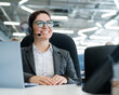 © Михаил Решетников - A happy female support operator is sitting at a desk and answering calls. Beautiful smiling woman talking to customers on a headset. Office employee in headphones.
