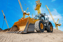 Excavator Or Bulldozer And Cranes On On Construction Site