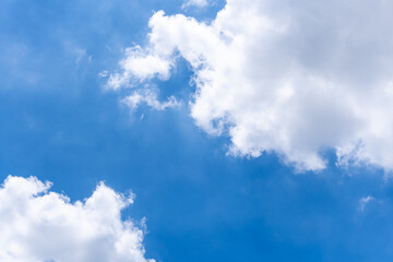 White clouds on bright blue sky in sunny day.