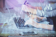 © peshkova - Multi exposure of woman hands typing on computer and financial graph hologram drawing. Stock market analysis concept.