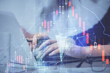 Multi exposure of woman hands typing on computer and financial graph hologram drawing. Stock market analysis concept.