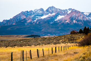 Wall Mural - The Sawtooth mountains and a log cabin at sunrise near  Stanley, Idaho.