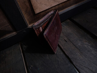 brown leather wallet with black wood background