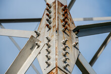 Fragment Of A Metal Construction With Bolts And Nuts. A High-voltage Power Transmission Tower. Power Engineering
