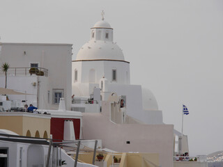 Typical urban landscape with a view of the church and the historical part of the town of Fira Santorini island, Greece.