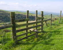 Wooden Stile Across A Fence, Leading From A Cliff Edge To The Valley Beyond.
