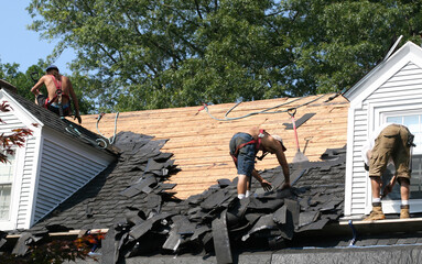 roofers removing old roof tiles