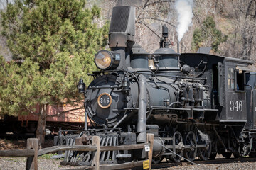 Refurbished and well maintained operating late nineteenth century steam powered locomotive with rolling stock