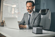 © Viacheslav Yakobchuk - European businessman wearing grey coat sitting on the office chair
