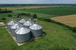 Agricultural silos on a farm, photos from above with a drone. Industrial agricultural granary, processing plant, elevator dryer, storage and drying of cereals, wheat, corn, soybeans, sunflowers.