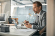 © Viacheslav Yakobchuk - Professional creative director wearing grey suit sitting at the white table