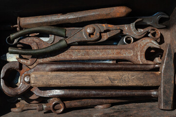  set of old rusty construction tools in a rusty old box