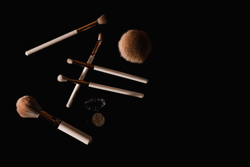 Canvas Print - Elegantly lit make-up brushes on a black background