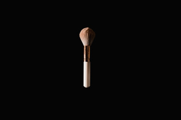 Wall Mural - Elegantly lit make-up brush on a black background