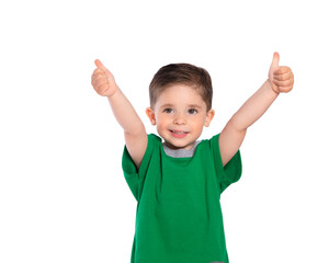 Portrait of a beautiful European boy 2 years old, the child smiles, raised his hands up and shows the class. A beautiful and happy child. Isolated on a white background in a green t-shirt.