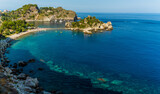 Fototapeta  - A view of the shoreline and Isola Bella near Taormina, Sicily in summer