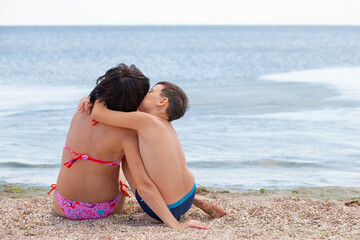 son with mother on the beach