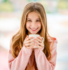 Wall Mural - Cheerful teenager holding white cup