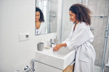 Female washing her hands in the bathroom