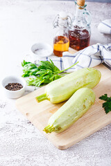 Sticker - Fresh zucchini on a wooden board with a knife