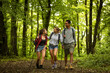© BalanceFormCreative - Group of young people hiking trough forest.Outdoors nature concept.