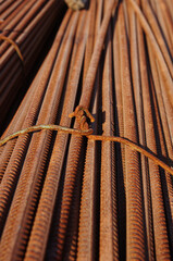  Stack of rusty bars tied with iron knot
