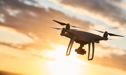 Wall Mural - drone with digital camera flying at sunset