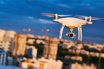 Wall Mural - drone with digital camera flying at city street