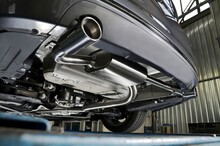 New Generation Of Sportive Mufflers. Oval Or Round Car Exhaust Tailpipe Chromed Made Of Stainless Steel On Powerful Sport Car Bumper. Close Up