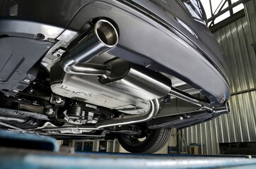 New generation of sportive mufflers. Oval or round Car Exhaust Tailpipe chromed made of stainless steel on powerful sport car bumper. Close up