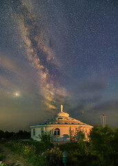 Wall Mural - Under the bright Milky Way, Mongolia yurts on the grassland are scattered.