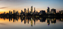 The Reflections Of The Melbourne City Skyline At Dusk In The Still Water Of Albert Park Lake