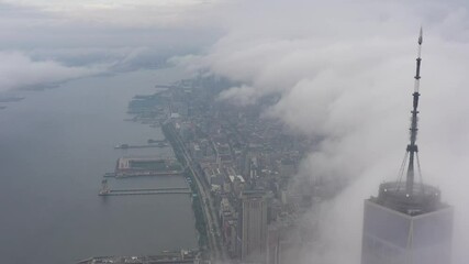 Wall Mural - 4K RAW Footage in D-log: Aerial view of One World Trade Center above the cloud, WTC 1, New York City Skyline / Cityscape at cloudy day. 